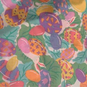 Colorful Easter Egg and Bunny tablecloth, eggs in bird nests and eggs.